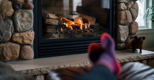 image of persons feet in front of a fireplace
