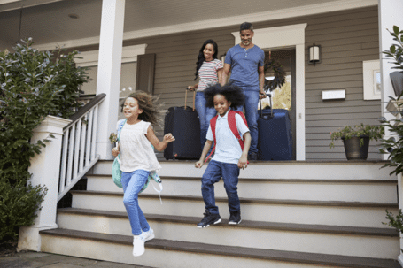 Family of four walking down porch steps
