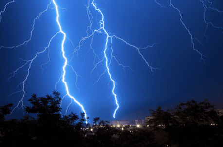 Blue lightening strikes in night sky