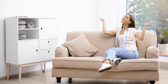 Woman looks content on beige sofa