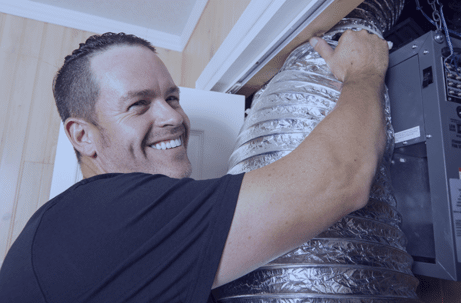 Smiling man replacing air ducts