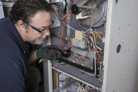 Male technician inspecting electrical box