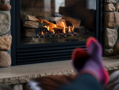 image of persons feet in front of a fireplace