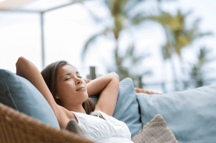 Woman relaxing on light blue couch