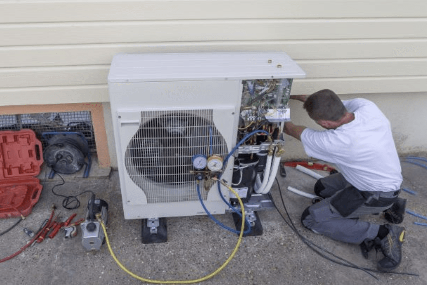 Technician repairing a heat pump