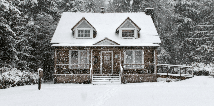 Outdoor view of home with a snowy roof