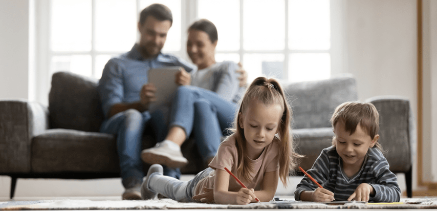 Family of four in bright living room